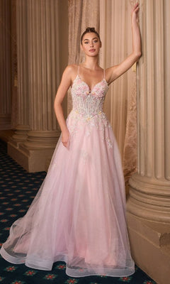 A woman wears the Classic Long Pink Prom Dress: Andrea and Leo A1477, featuring thin straps and embroidered flowers, as she stands against ornate columns and a curtain in an elegant interior.