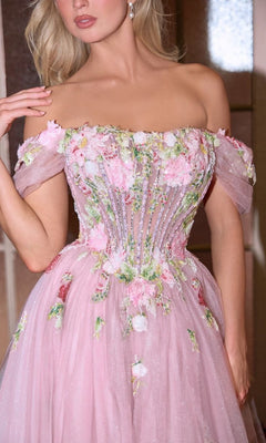A woman wears the Andrea and Leo A1479 Mauve Pink Prom Ball Gown, an off-the-shoulder dress with floral embroidery, beaded accents, a fitted bodice, and a flowing tulle skirt.