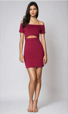 A woman faces forward in the Off-the-Shoulder Short Cut-Out Party Dress 3076, maroon with a front cut-out, paired with nude high-heeled sandals against a plain light background.