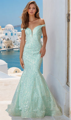 Woman in the Off-the-Shoulder Sequin Mermaid Prom Dress 2412 in mint green, posing outdoors with white buildings and blue domes in the background.