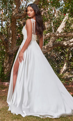 A woman poses gracefully outdoors among trees, wearing the Long White Satin A-Line Formal Dress BD104W, featuring a high slit and ribbon shoulder straps.