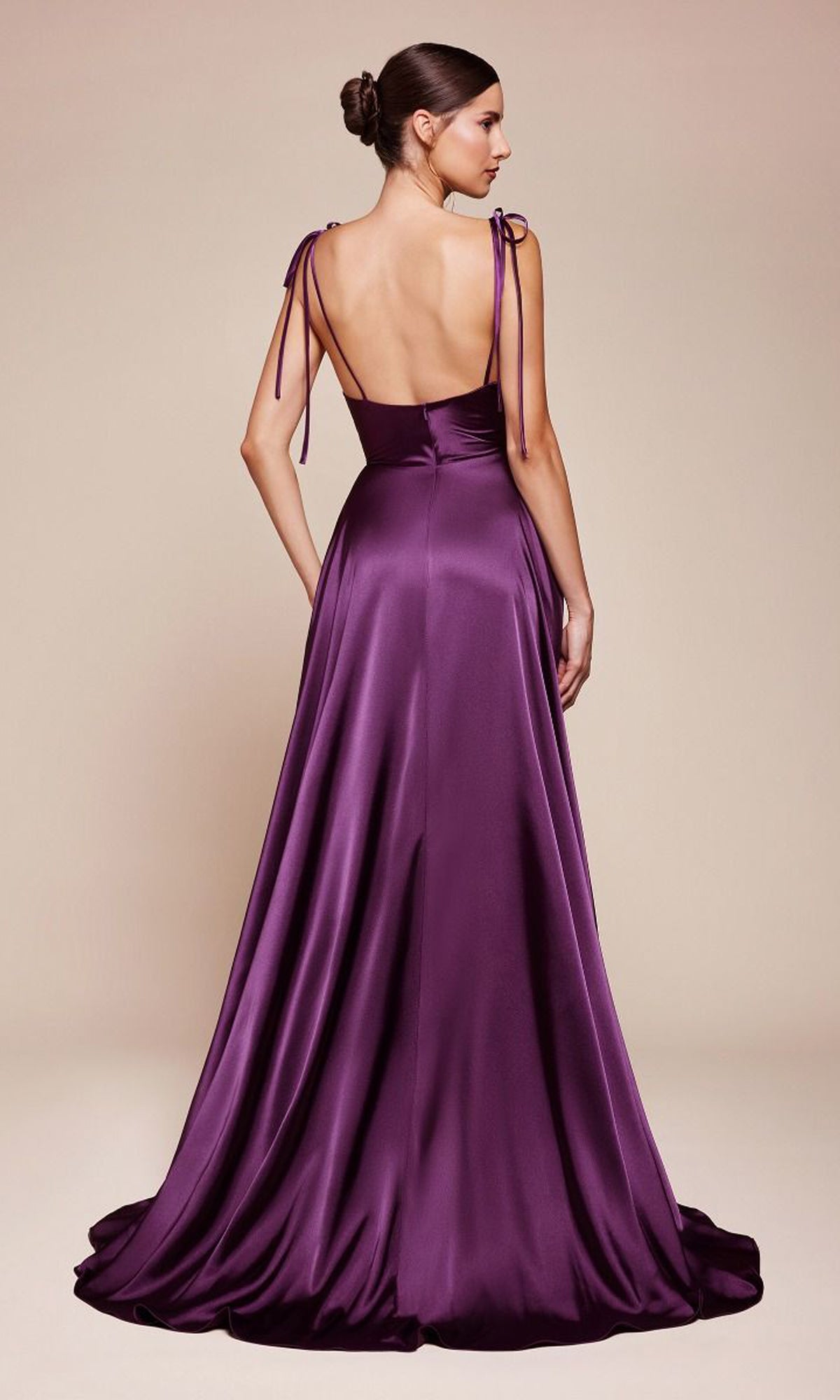 A woman faces away, wearing the Ladivine BD104: a cowl-neck long satin prom dress in purple, featuring shoulder ties, a backless design, and a slight train—an elegant yet affordable evening gown.