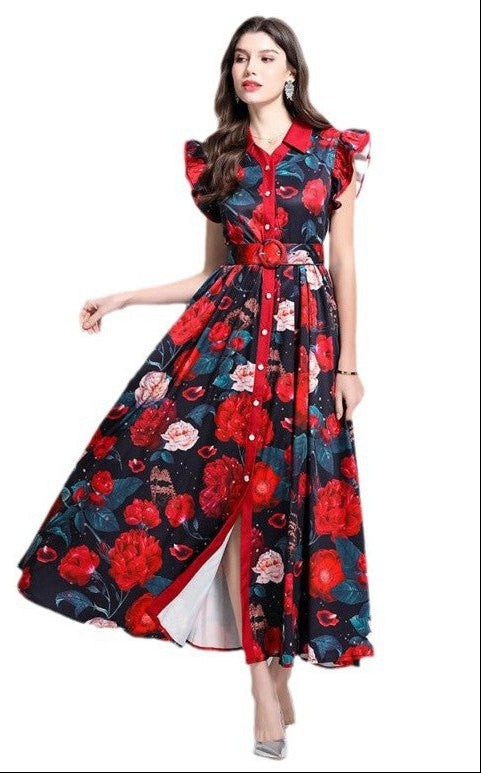 Model wearing multi-color flower maxi dress in front of white background.