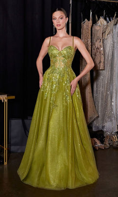 A woman poses backstage in the Ladivine C177, a lime green, floor-length prom dress with thin straps, an embellished bodice, and sequin details, standing before a rack of dresses.