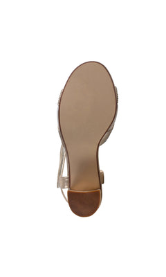 Bottom view of the Cam Champagne Prom Shoes: Touch Ups 4639, showing a smooth beige sole, black heel, textured brown heel tip, and a velcro ankle strap across the back.