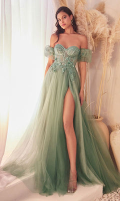 A woman stands indoors beside decorative pampas grass, wearing the Ladivine CB080 Glitter Tulle Ball Gown Prom Dress in light green with an off-the-shoulder corset, high slit, and sheer detailing.