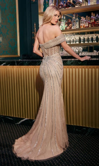 A woman in the Ladivine CB160 Asymmetrical Beaded Long Prom Gown stands at a bar, facing away from the camera.