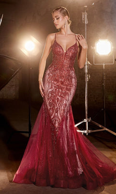 A woman poses gracefully under studio lights in a dim setting, wearing the Low V-Neck Long Glitter Mermaid Prom Dress CC2253.