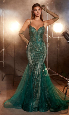 Model wears the Low V-Neck Long Glitter Mermaid Prom Dress CC2253 in emerald green with sheer gloves, posing in a studio under bright lights against a dark background.