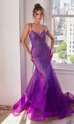 Woman in a Low V-Neck Long Glitter Mermaid Prom Dress CC2253 with thin straps stands by a window, cityscape visible in daylight.