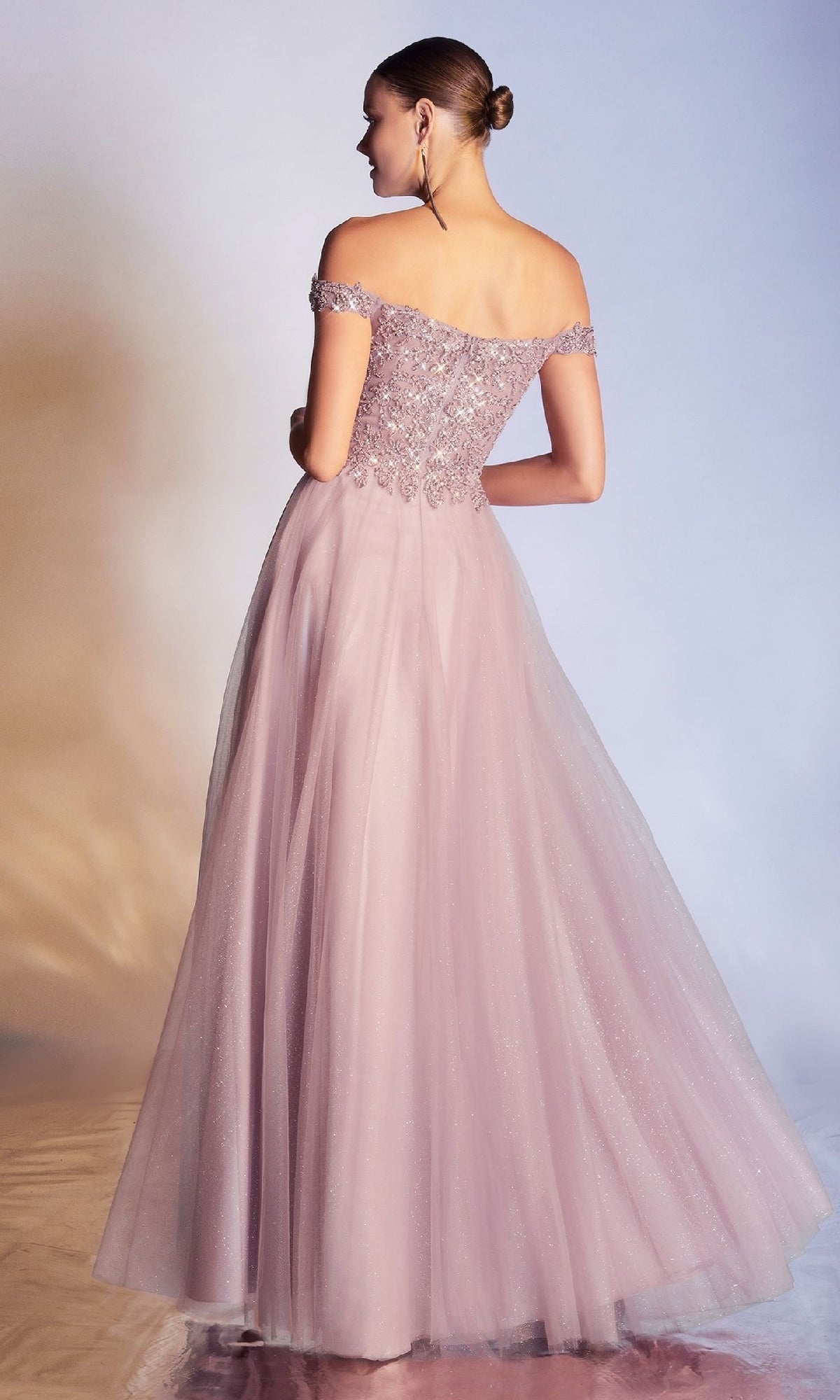 Woman wearing the Ladivine CD0177 Beaded-Bodice Long Prom Dress in blush pink, featuring an off-the-shoulder design with a fitted bodice and full tulle skirt, standing with her back to the camera.