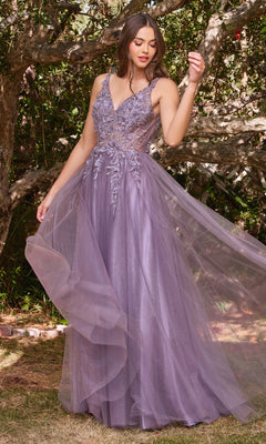 A woman stands outdoors in the Glitter Tulle Illusion Prom Dress: Ladivine CD0181, a long lavender gown with floral embroidery and a dreamy tulle skirt. She is surrounded by trees and lush greenery.