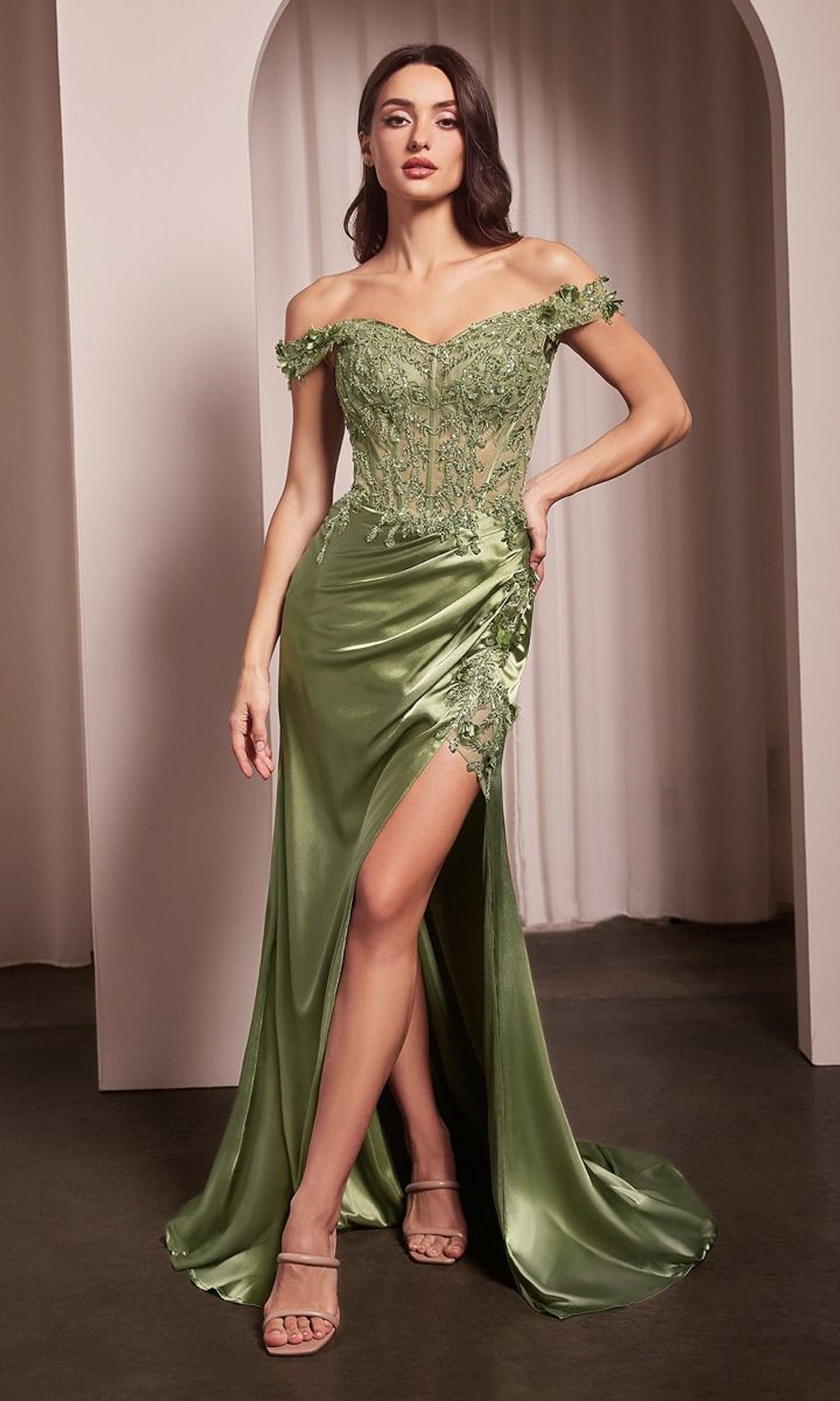 A woman poses gracefully before a white curtain in the Off-the-Shoulder Long Sweetheart Prom Dress CD0186 in Greenery, featuring floral lace, glittery embroidery, and a high leg slit.