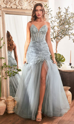 A woman wearing the Strapless Beaded Long Mermaid Prom Dress CD0214 with a light blue beaded bodice, tulle skirt, and thigh-high slit poses indoors by an ornate mirror and plants, highlighting this elegant formal gown.
