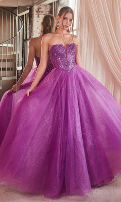 A woman stands in front of a mirror, holding out the sides of her glittery purple tulle skirt while wearing the Lace-Up Strapless Long Glitter Prom Dress CD0217.