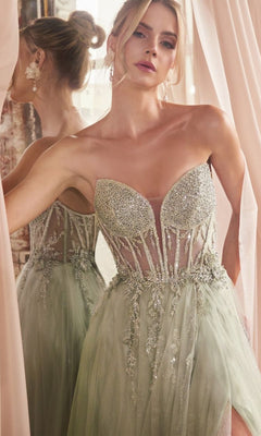 A woman in the Strapless Sheer-Corset Long Prom Ball Gown CD0230, featuring sparkling silver glitter tulle, stands by a mirror with sheer curtains behind her.