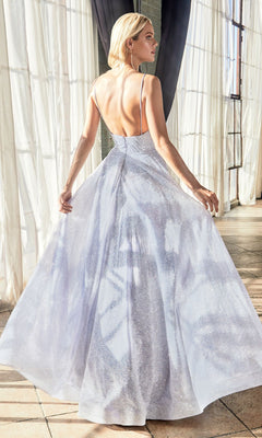 A woman stands indoors by large windows, wearing the Light Blue Glitter Long A-Line Prom Dress CD205 featuring a sleeveless design, shimmering fabric, low back, and full formal skirt.