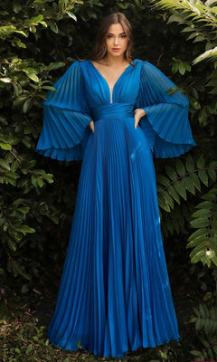 A woman stands before leafy greenery, wearing the Long Bell-Sleeve Pleated Long Formal Dress CD242 in teal—featuring flared sleeves and a deep V-neckline, it's an elegant a-line choice for formal evening occasions.