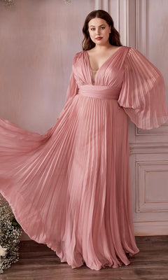 A woman stands indoors wearing the Long Bell-Sleeve Pleated Long Formal Dress CD242 in rose gold, featuring flowy bell sleeves and a deep V-neckline—an elegant choice for formal occasions.