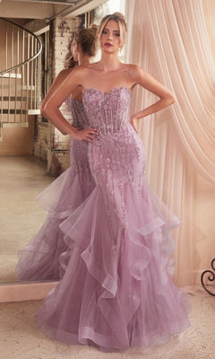 A woman stands gracefully before a mirror wearing the Strapless Sweetheart Long Mermaid Prom Dress CD332 in lilac, featuring bead embellishments and tulle ruffles.