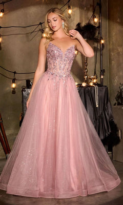 A woman wears the Lace-Up Strapless Prom Ball Gown Ladivine CD721 with a beaded corset and pink tulle skirt, standing indoors near string lights and décor.
