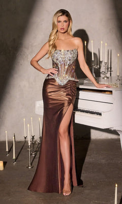 A woman in the Strapless Long Gold Prom Gown: Ladivine CD733 stands by a white piano, surrounded by lit candles in a dimly lit room.