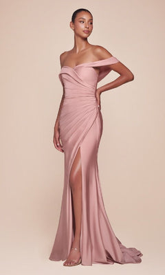 A woman poses in the Off-the-Shoulder Long Prom Dress: Ladivine CD790, a blush pink gown featuring a thigh-high slit and ruched detailing, styled with strappy heels against a plain beige background.