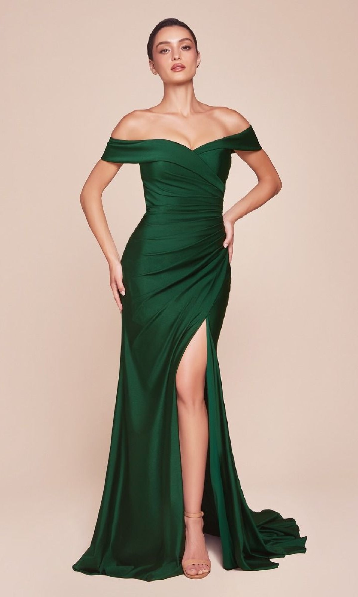 A woman models the Ladivine CD790, an off-the-shoulder long prom dress in dark green with a ruched bodice and high slit, set against a plain beige background.