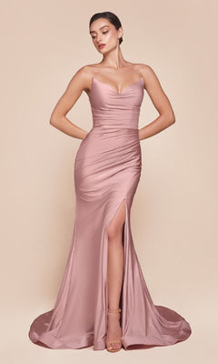 A woman models the Lace-Up Strapless Long Prom Dress: Ladivine CD791 in blush pink satin, featuring a fitted silhouette, booty-contouring ruching, and a thigh-high slit against a plain beige background.