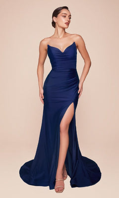 A woman models the Ladivine CD791 Lace-Up Strapless Long Prom Dress in deep blue, featuring a sweetheart neckline, high slit, and open lace-up back, standing before a plain beige background.