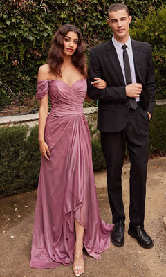 A woman in the Wrap-Waist Long Glitter Prom Dress CD878 poses outdoors amid lush greenery beside a man in a black suit and tie.