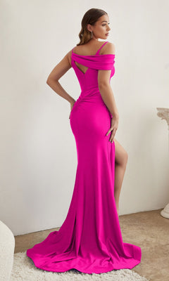 A woman stands indoors, facing partly away from the camera, wearing the Asymmetrical Long Glitter Prom Dress CD881 in bright pink with off-the-shoulder sleeves and a thigh-high slit.