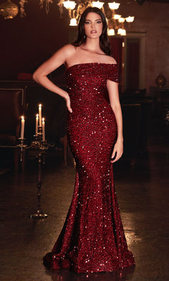 A woman stands indoors in soft candlelight, wearing the Ladivine CD980 One-Shoulder Long Sequin Prom Dress, featuring a glamorous fitted silhouette.