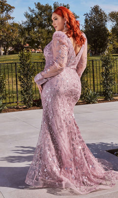 A woman with long red hair stands outdoors on a paved walkway wearing the Long Sleeve Long Glitter-Lace Prom Dress CD989 in light purple, with trees and a black fence in the background.
