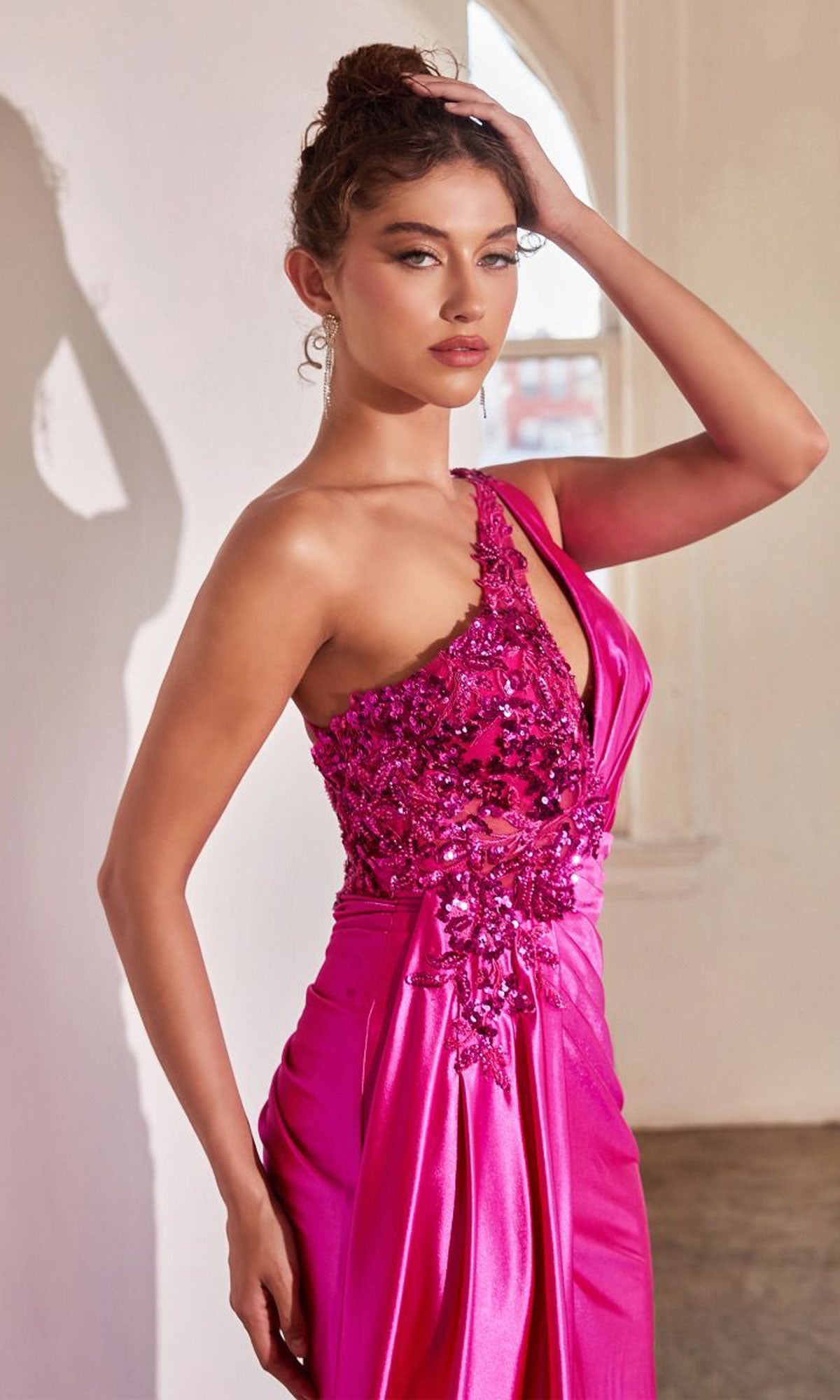 A woman poses indoors in the Keyhole One-Shoulder Long Satin Prom Dress CDS454, a vibrant pink gown with a single shoulder design.