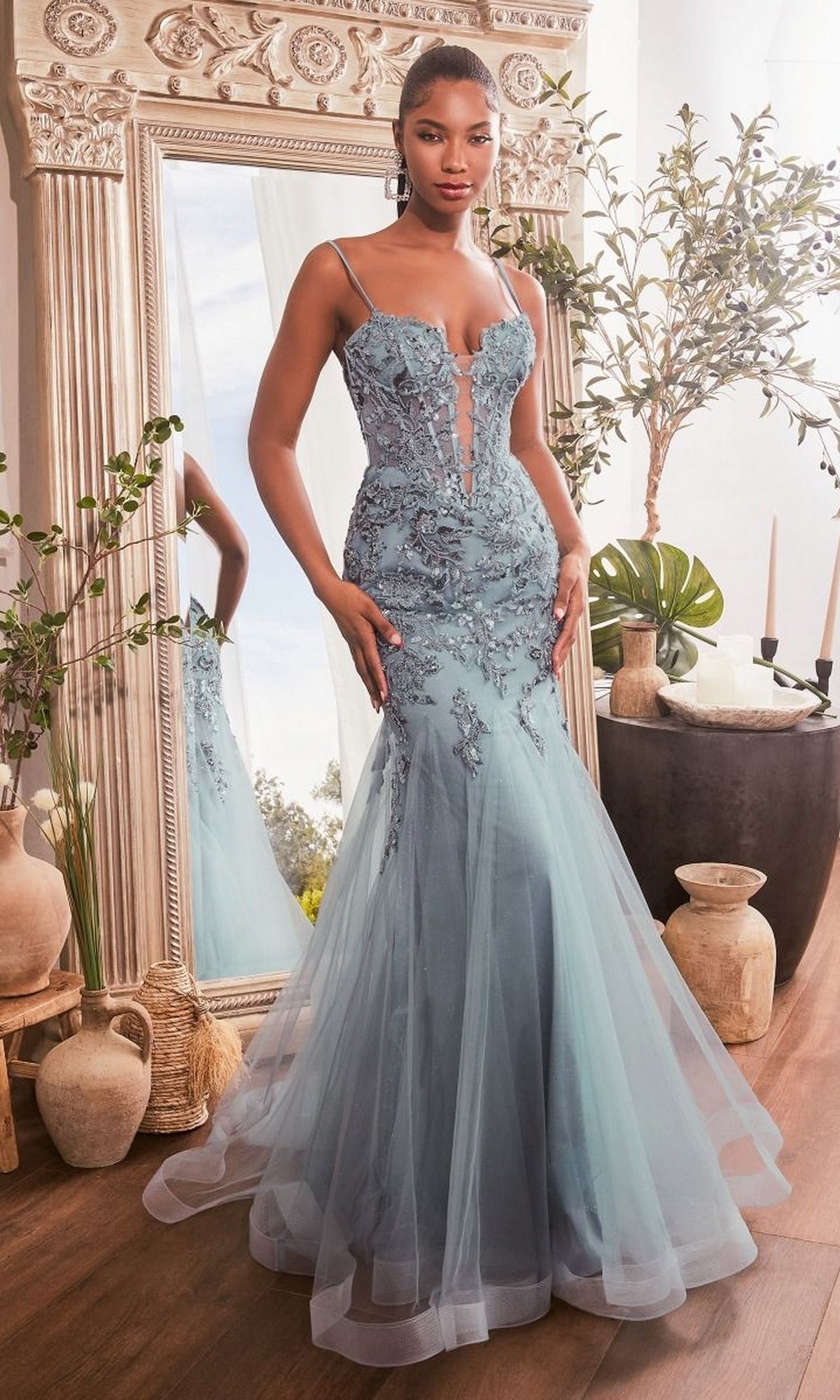A woman stands indoors wearing the Sequin-Embroidered Long Mermaid Prom Dress CDS488, featuring a floor-length silhouette and sparkling details, in front of a large ornate mirror.