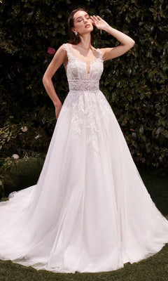 A woman poses outdoors in the Ladivine CDS511W long wedding dress, featuring a lace-embroidered bodice and full tulle skirt, with one hand gracefully raised near her face.