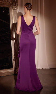 A woman in the Drape-Front Long Prom Dress: Ladivine CH377, a sleeveless floor-length purple gown, stands with her back to the camera near a large ornate mirror and white drape.