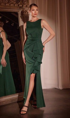 A woman in the Ladivine CH377 drape-front long prom dress, featuring a sleeveless dark green design with ruffle detail and a thigh-high slit, stands beside an ornate mirror.