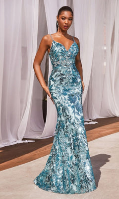 A woman stands in the Ladivine CM350 Lace-Up Long Sequin Formal Dress, a sleeveless blue gown with sequin floral patterns and a fitted silhouette, set against sheer white curtains.