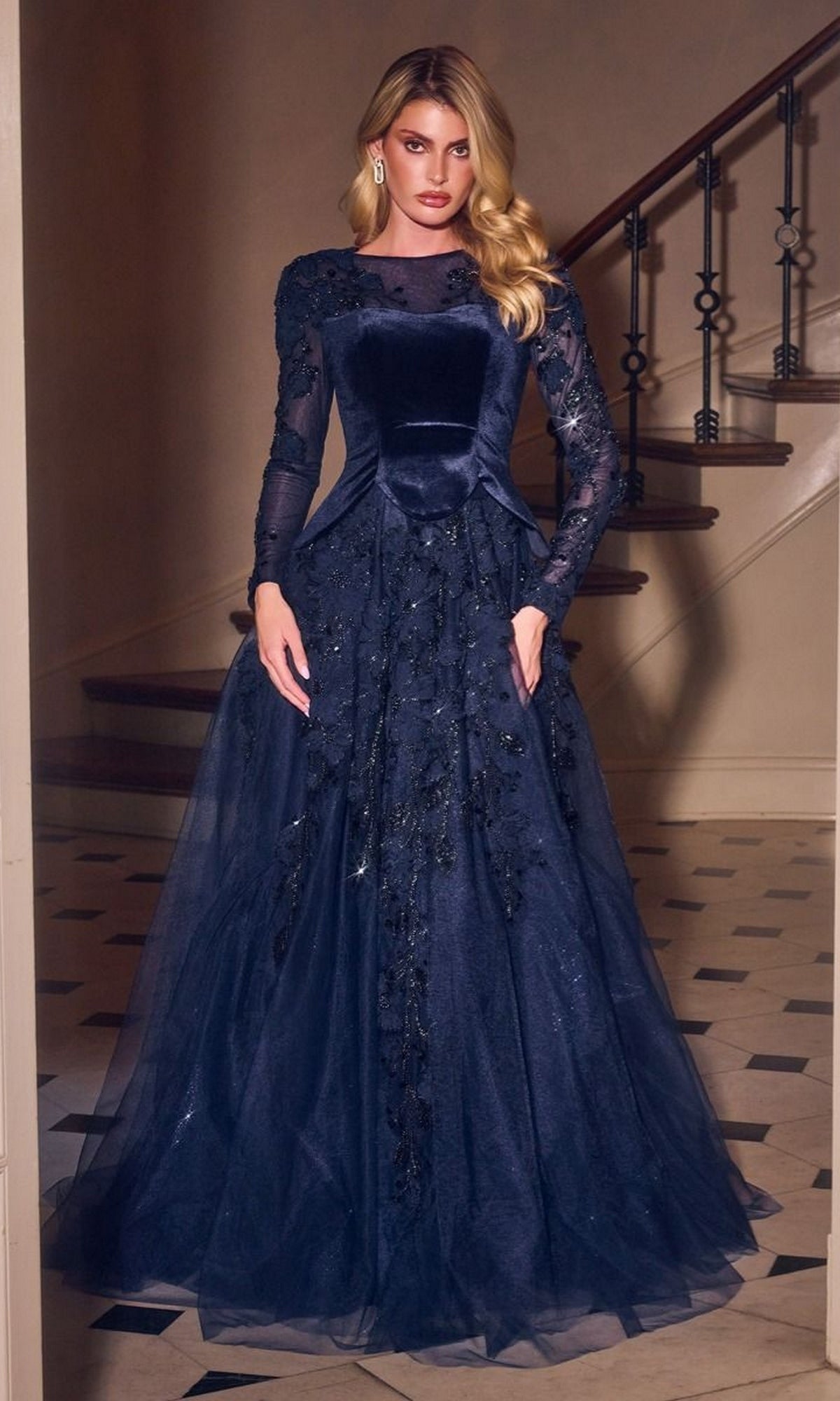 Ladivine CM394 floor-length navy blue formal gown with long sheer sleeves, a velvet bodice, and an A-line glitter tulle skirt featuring beaded floral embroidery.