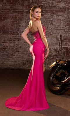 A woman in a bright pink Sheer-Corset Strapless Prom Gown: Ladivine CW301 poses beside a motorcycle and in front of a brick wall, her back slightly turned.