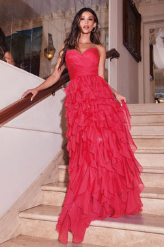 A woman in the Ladivine CZ0027 Strapless Long Ruffle Prom Dress stands gracefully on a staircase in an elegant indoor setting.