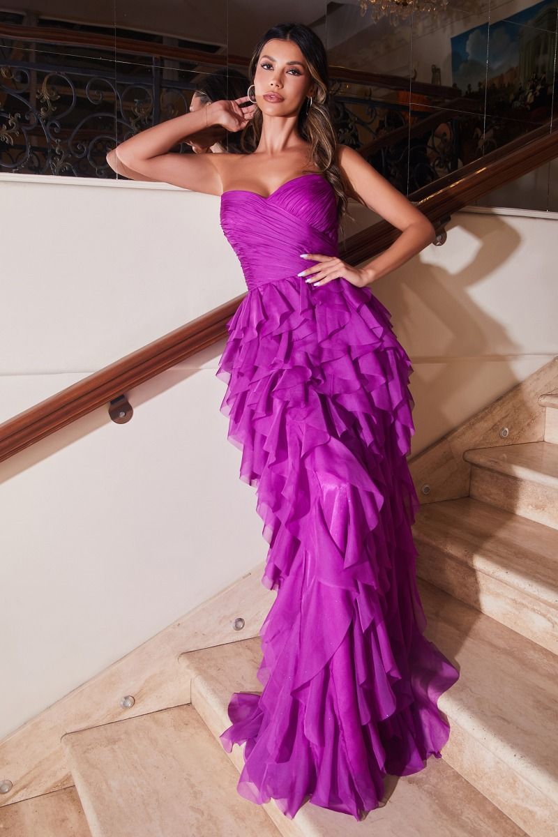 A woman stands on a staircase, one hand on the railing and the other on her hip, wearing the Ladivine CZ0027 Strapless Long Ruffle Prom Dress in bright purple.