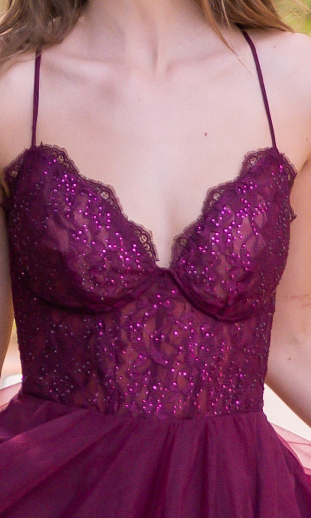A close-up of a woman's upper torso wearing the Velvi Long Sweetheart A-Line Prom Dress Dani, a sleeveless deep purple gown with lace, sequins, and thin straps.