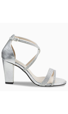 The Daphne Silver Prom Shoes (Touch Ups 4617) feature a block heel, ankle strap, crisscross design, and open toe—ideal for a glamorous night out.