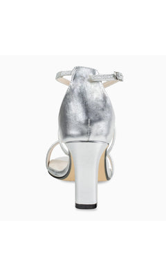 Rear view of the Daphne Silver Prom Shoes: Touch Ups 4617, showcasing a strappy silver design with ankle strap, open heel, and light-colored sole on a plain white background.