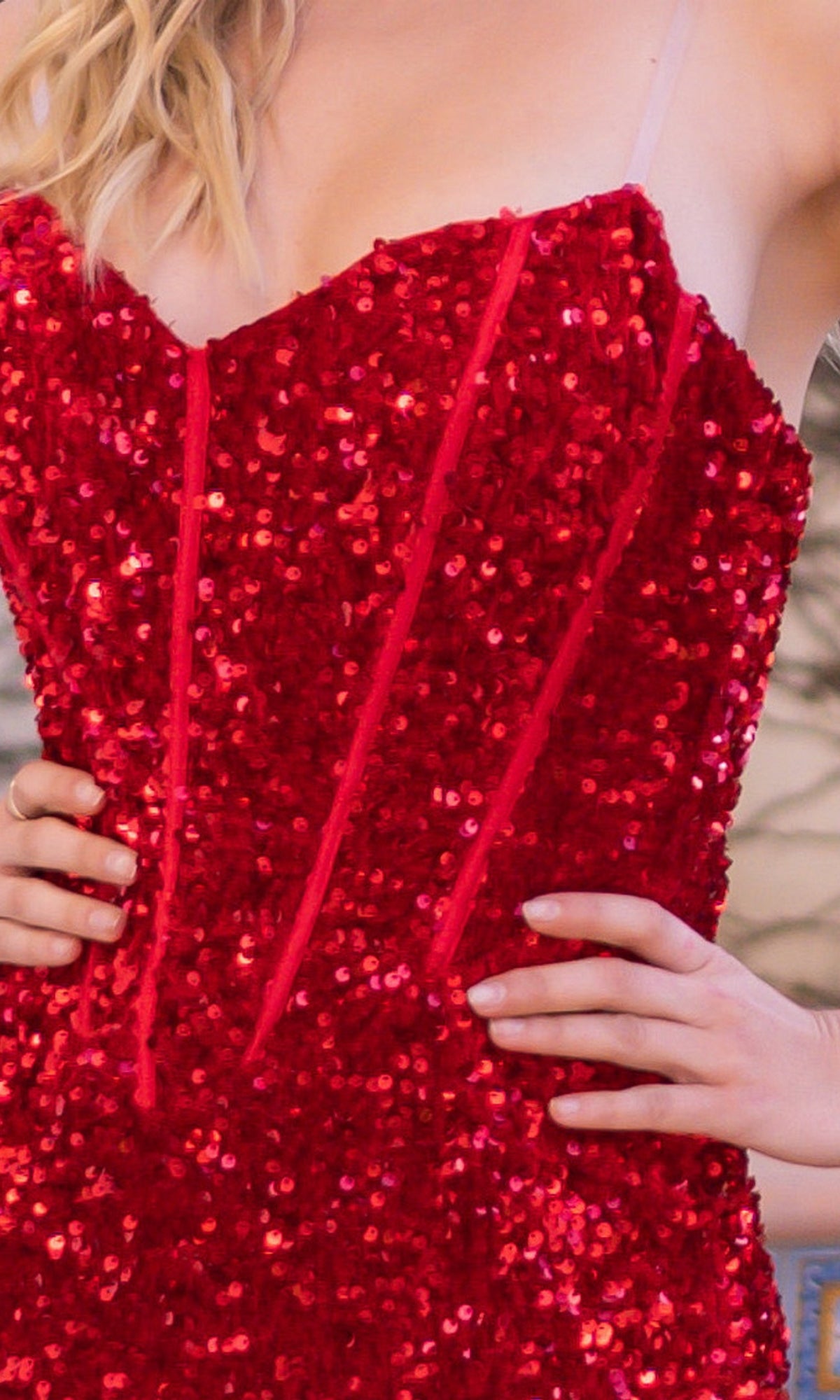 Model wearing the Velvi Clear-Strap Long Sequin Prom Dress Dover in red, hands on waist, highlighting its elegant and formal style.