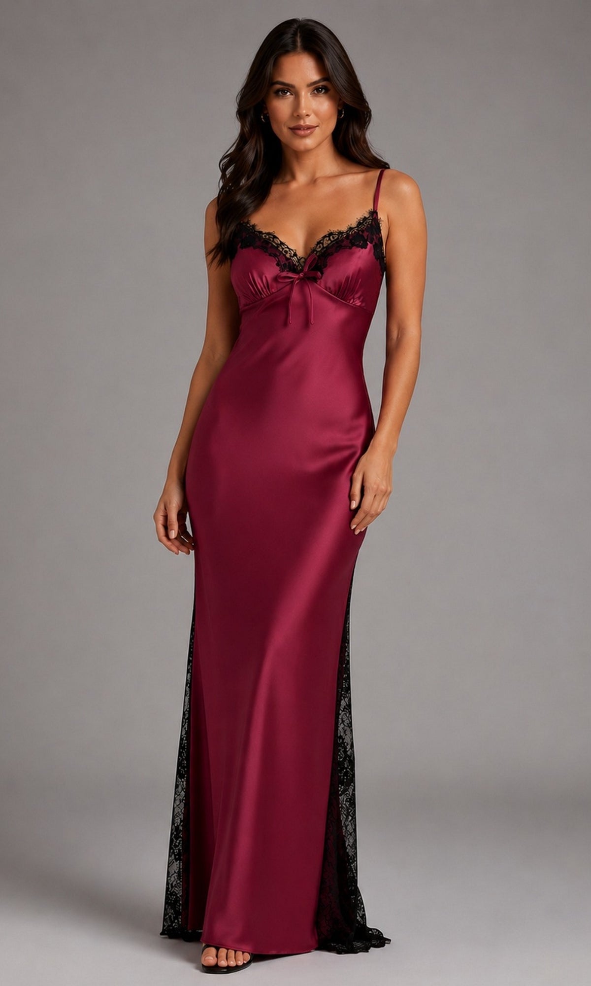 Woman in a floor-length, sleeveless Long Prom Dress: Eureka EK171 in burgundy with black lace trim, standing against a plain gray background.