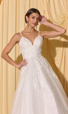 A woman in the Long Prom Dress: Eureka EK210—a white lace gown with thin straps and 3D floral appliques—stands before yellow drapes, posing with one hand near her head.